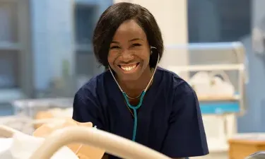 Nashville LPN to BSN Nursing Student with Stethoscope Practicing on Dummy in Simulation Lab