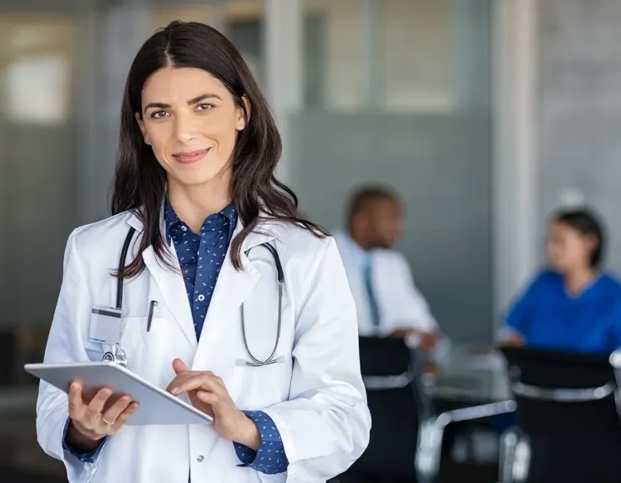 Nurse practitioner smiling in office after meeting with hospital administrators