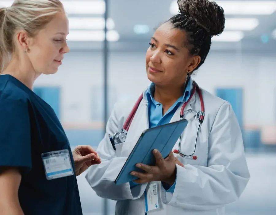 Nurse Practitioner Showing Patient Chart to Registered Nurse